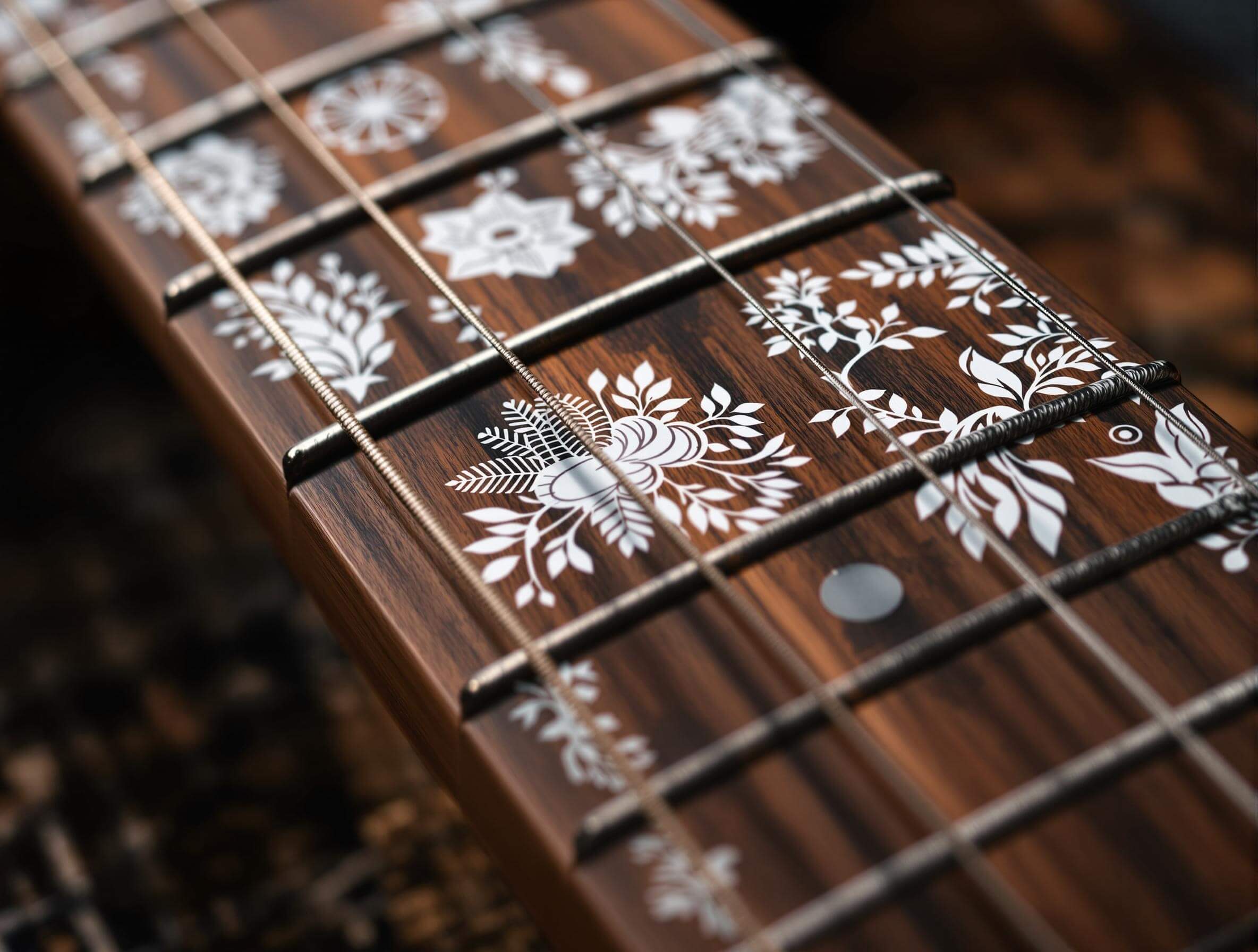 A guitar fretboard with intricate white floral stickers, highlighting the natural wood grain.