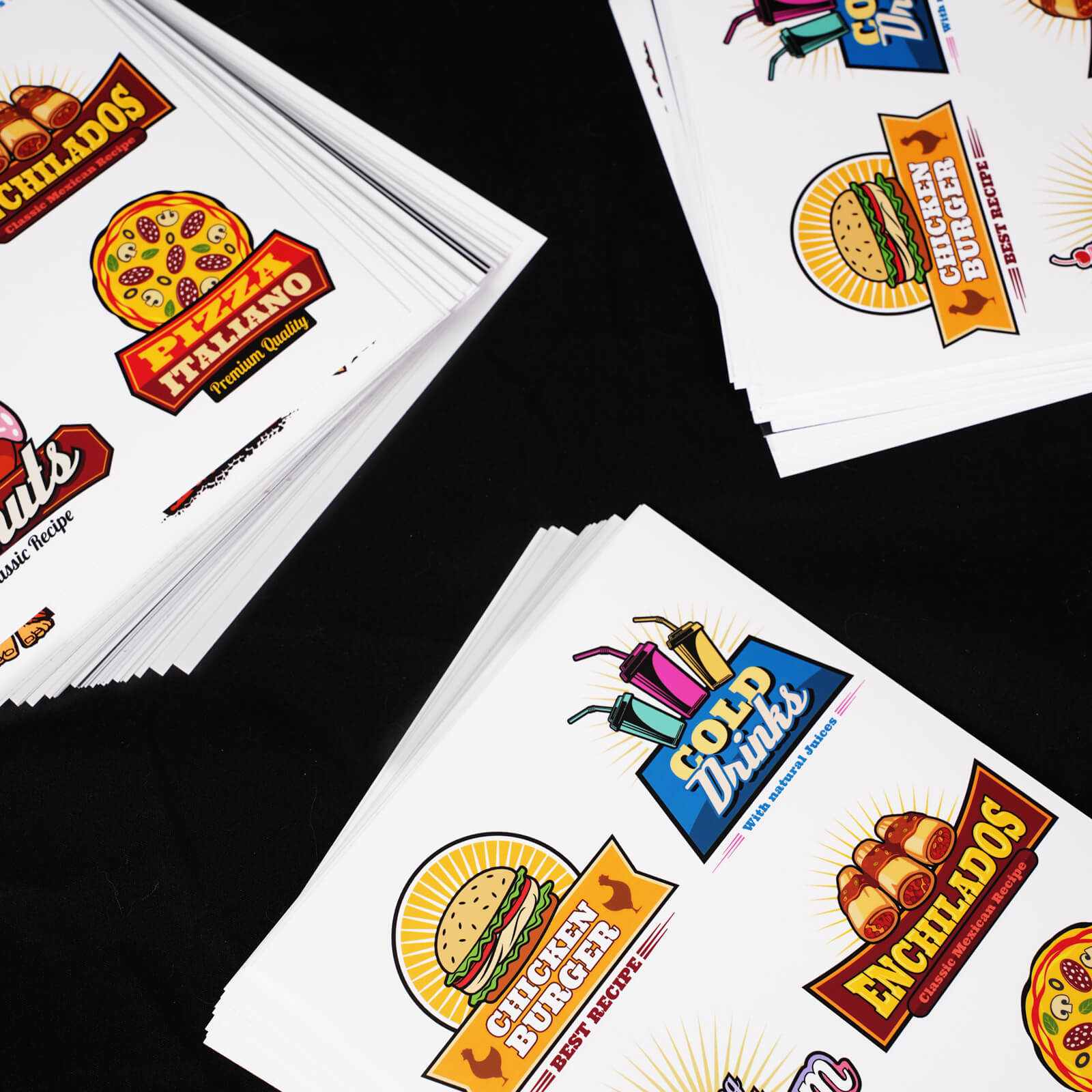 Food-themed vinyl sticker sheets with designs like burgers, pizza, and cold drinks on a black background.